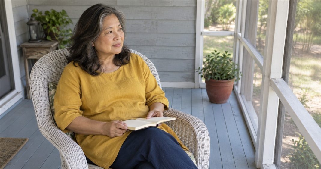 Stressful relationship — private porch reflection 2700 A woman in a mustard tunic holding an open notebook in a white wicker chair on a screened porch.