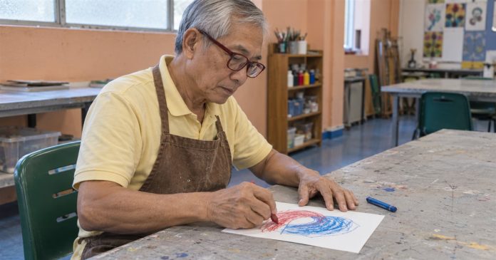 Empath values two color expression realistic cover 3605 An older man wearing red glasses and a brown apron draws red and blue shapes on paper in an art room.