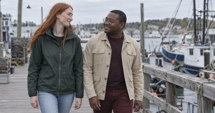 Realistic partner conversation 4003 Two adults smiling at each other while walking along a harbor boardwalk