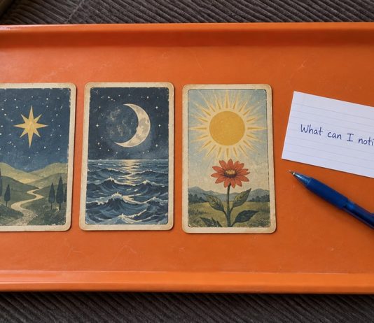 Three symbolic cards and a handwritten question, What can I notice?, on an orange tray