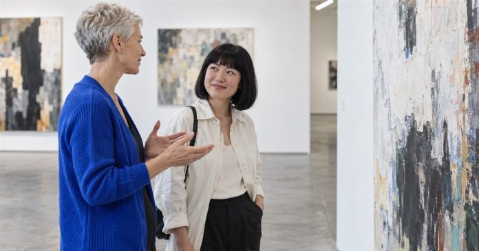 Gemini lady — gallery conversation Two women discussing an abstract painting in a contemporary art gallery